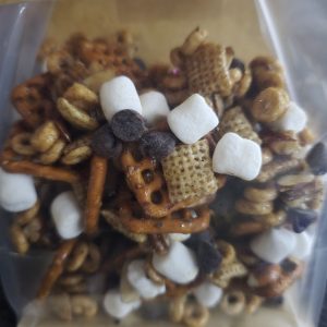 Pumpkin Spice Snack Mix in a clear bag with pretzels, cereal, marshmallows, and chocolate chips