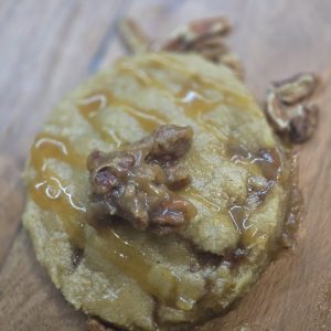 Pecan pie cookie topped with pecans and sweet drizzle