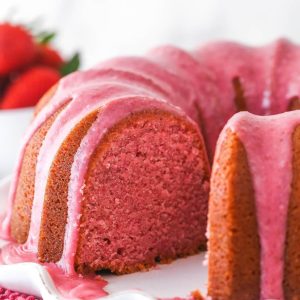 Strawberry pound cake with pink glaze and a cut slice